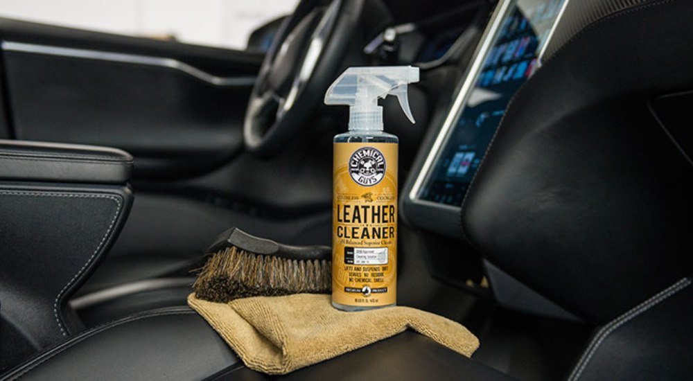 Bottle of best car upholstery cleaner on car seats
