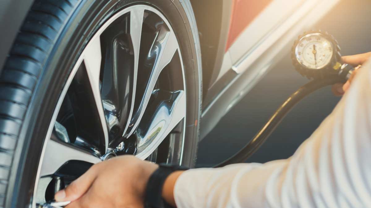 Man inspecting tire pressure sensor fault