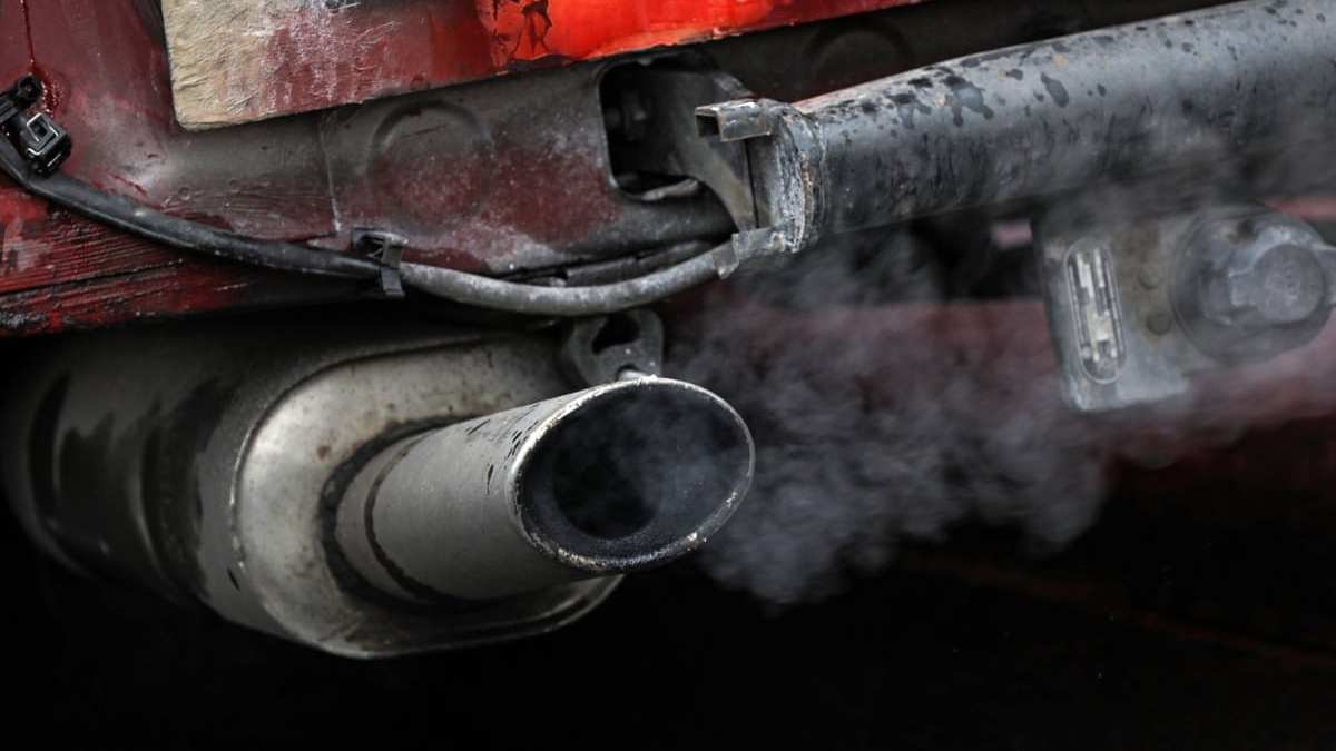 Old car with white smoke from exhaust 